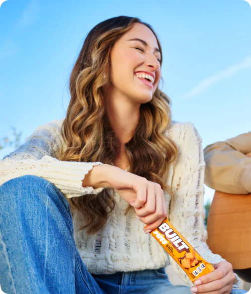 Woman laughing and socializing while holding a BUILT Puff
